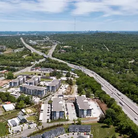 Aerial view of community off Charlotte Pike with Nashville skyline in the background at Camden West Nashville apartments in Nashville, TN