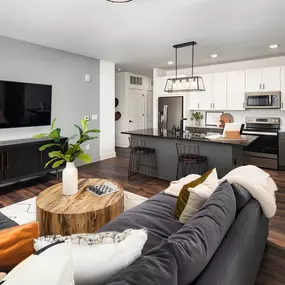 Living room and kitchen with wood-style flooring at Camden West Nashville apartments in Nashville, TN