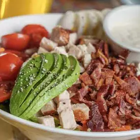 A delicious Cobb Salad with fresh sliced avocado.