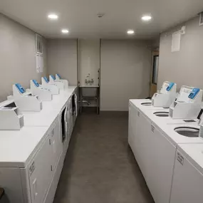 A laundromat with rows of washers and dryers