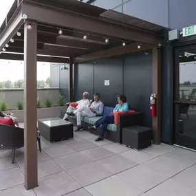 A group of people are sitting on a patio.