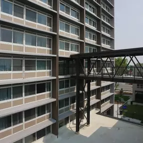 A modern building with a metal walkway connecting the floors