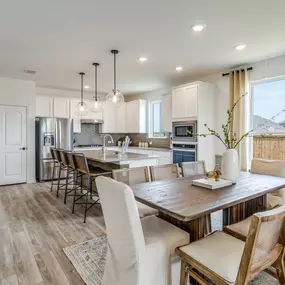 Open kitchen and dining in Emory floor plan, found in Dove Song new construction homes in Marion, TX