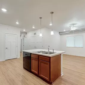 A kitchen with a sink and a refrigerator