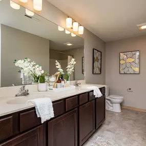 Furnished bathroom with large mirrors