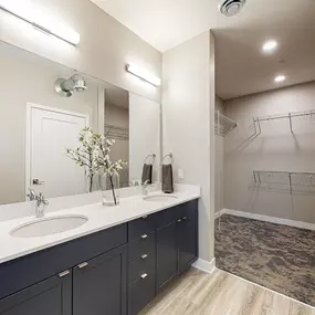 Furnished bathroom with large mirror