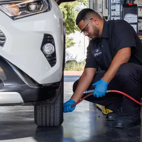 Tech adding air to tire