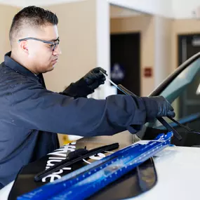 Tech changing windshield wiper.