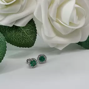 A touch of timeless elegance—these emerald earrings with a sparkling diamond halo, are the perfect blend of bold and classic.