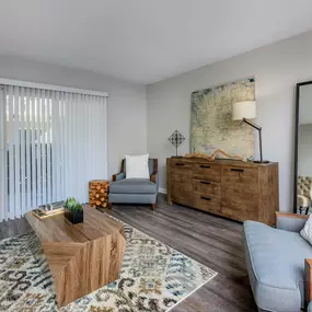 A living room with a wooden coffee table and a grey couch.