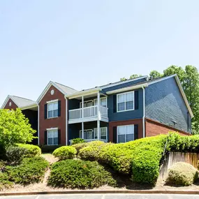 A building with a red brick facade and a balcony