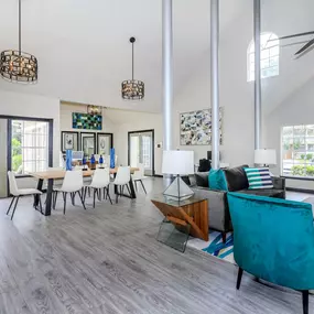 a living room and dining room with a table and chairs