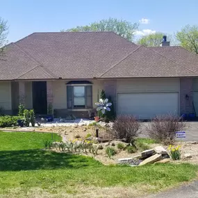 The house features a sloped roof with a functional gutter system designed to direct rainwater away, protecting the exterior and foundation.