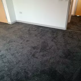 Black speckled carpet fitted in a bedroom