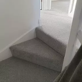 Grey twist pile carpet fitted on a landing and a bedroom.