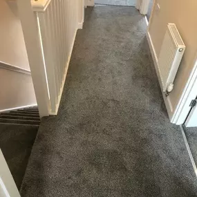 Dark grey carpet fitted on a landing and in 3 bedrooms.