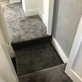 Dark grey, soft pile carpet fitted on a landing and 2 bedrooms