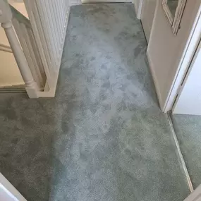 Mint green carpet fitted on a landing and stairs