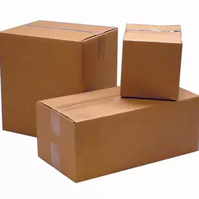 Three sealed brown corrugated shipping boxes of varying sizes, stacked and positioned to showcase their sturdy construction and secure closure with packing tape. These cube and rectangular boxes are ideal for shipping, storage, and moving, providing reliable protection for various items.