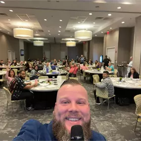 Community Impact in Action
Jerrad Havins connects with a packed room of motivated professionals, leading a workshop focused on financial empowerment and opportunity.