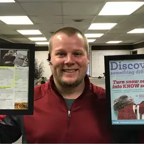 A Legacy of Education
Jerrad proudly displays framed articles recognizing his commitment to financial education in local communities through impactful programming.