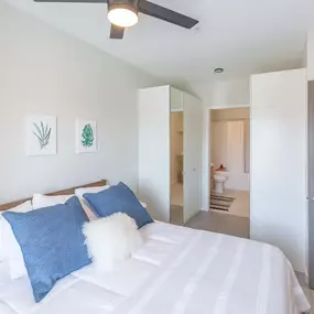 Furnished bedroom with ceiling fan