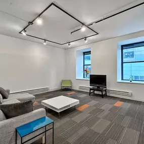 Living room with sofa, TV and large windows