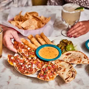 Appetizer Plate - Queso, bean & cheese panchos, fajita chicken quesadillas & chicken flautas with guacamole & sour cream.