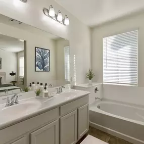 Dual sink vanity in master bathroom with soaking tub