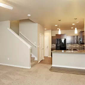 Open kitchen with stairs & refrigerator with ice maker