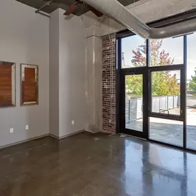 Room with built-in bookshelves and large windows