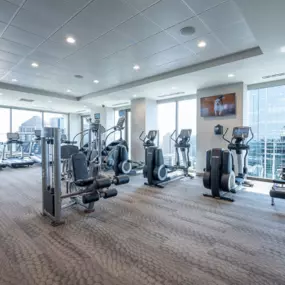 This image features the state-of-the-art fitness center at Atlantic House Midtown, equipped with a variety of cardio machines, strength training equipment, and free weights. Floor-to-ceiling windows provide stunning city views, creating an open and energized workout environment in the heart of Atlanta.