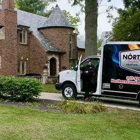 Northern Comfort Systems truck outside of a house