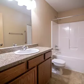 Bathroom with bath tub, sink and large mirror