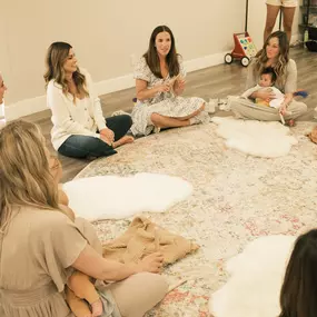 Two instructors lead a discussion with the new moms in class