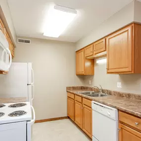 a kitchen with white appliances and granite counter tops