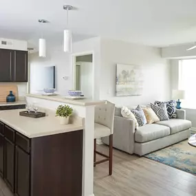 a living room and kitchen with a couch and a table
