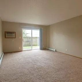 an empty living room with a sliding glass door
