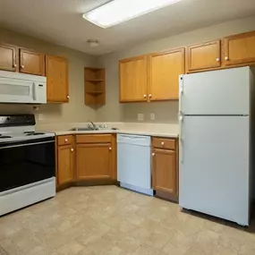 a kitchen with white appliances and wooden cabinets