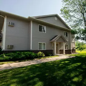 house with a grey siding and a small porch