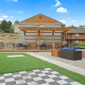 A large wooden building with a checkered pattern on the ground in front of it.