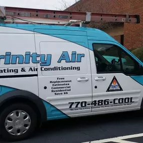 Trinity Air Heating & Air Conditioning van near a building