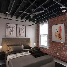 A bedroom with a large bed and a brick wall