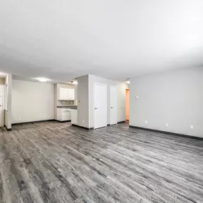 A spacious room with grey flooring and white walls