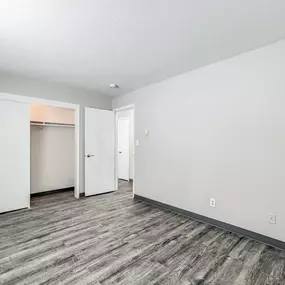 A room with a grey carpet and white walls