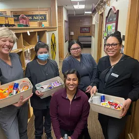 Dental Depot's Midwest City Dental Team holds boxes of candy for patients.