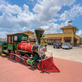 Exterior image of Dental Depot's Moore dentist office with a model train in front.