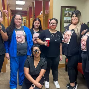 Dental Depot's North Penn dental team poses with pictures of Dr. Vu and Dr. Salous on their shirts.
