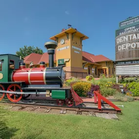 Dental Depot Central OKC Exterior view with model train and water tower in the foreground