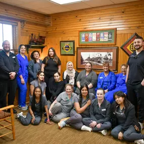 The full dental team at Dental Depot's Northwest OKC Dental clinic posing in the reception area